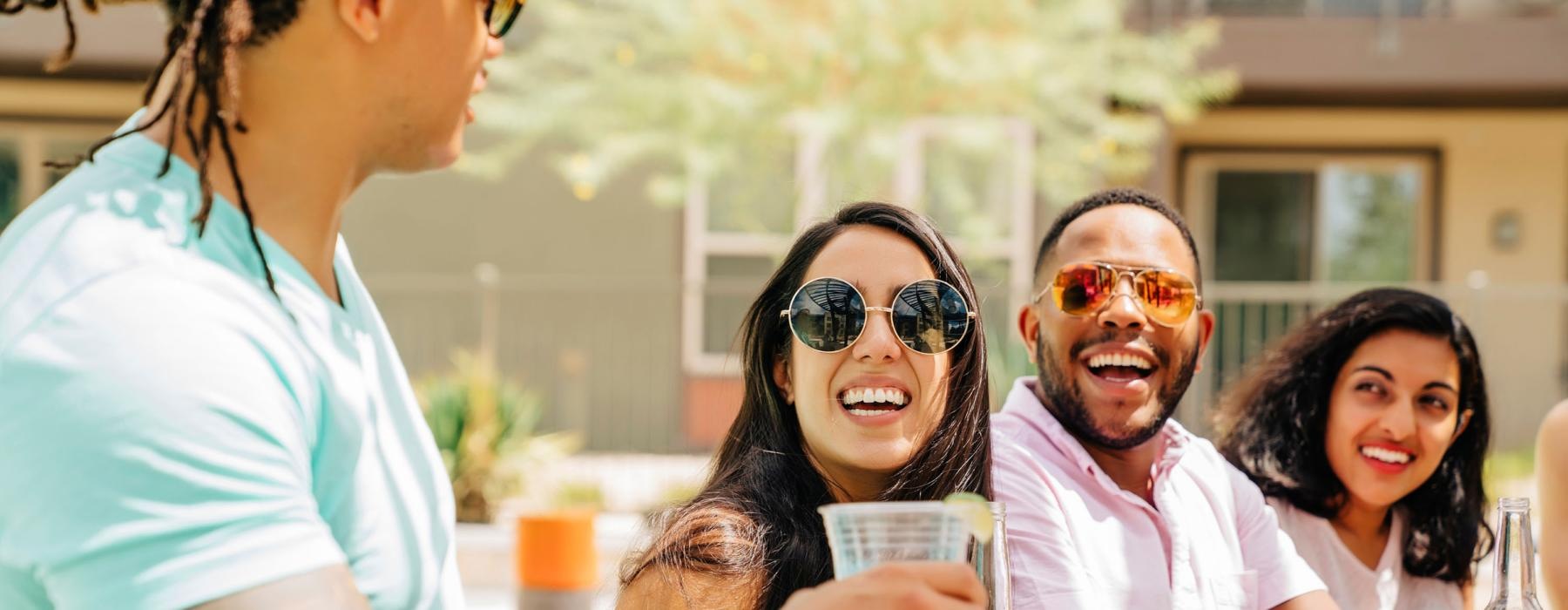 a group of people sitting at a table with food