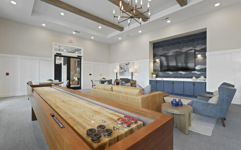 a living room with a large tv and couches