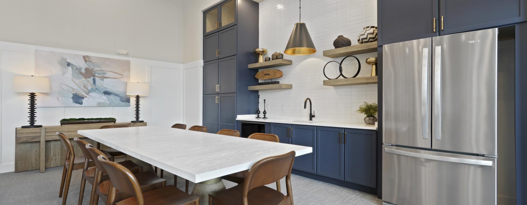 a kitchen with a dining table and a refrigerator