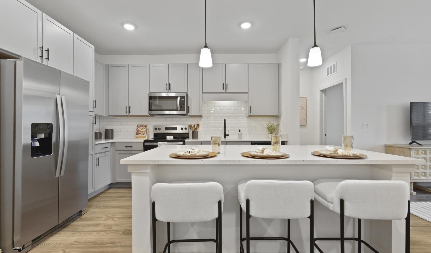 a kitchen with a table and chairs